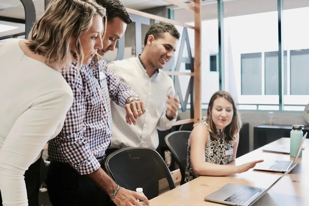 Team members collaborating to incorporate AI knowledge management tools in their workflow